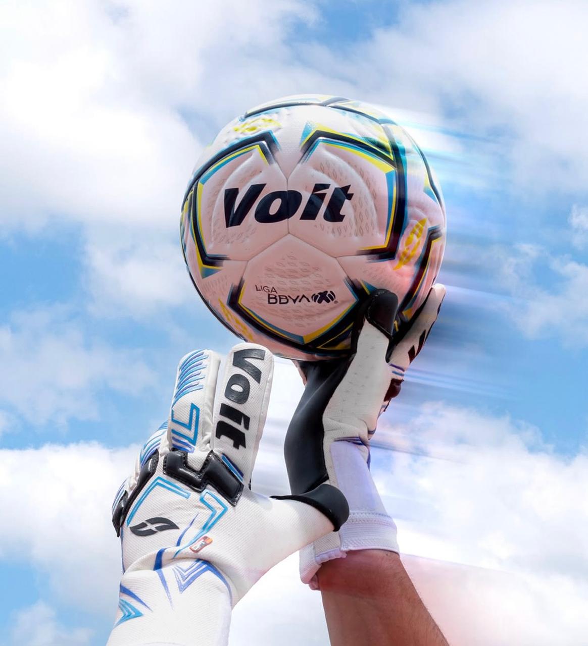 Voit ball held in goalkeeper gloves against the sky
